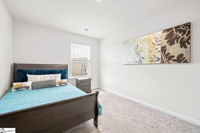 carpeted bedroom featuring visible vents and baseboards