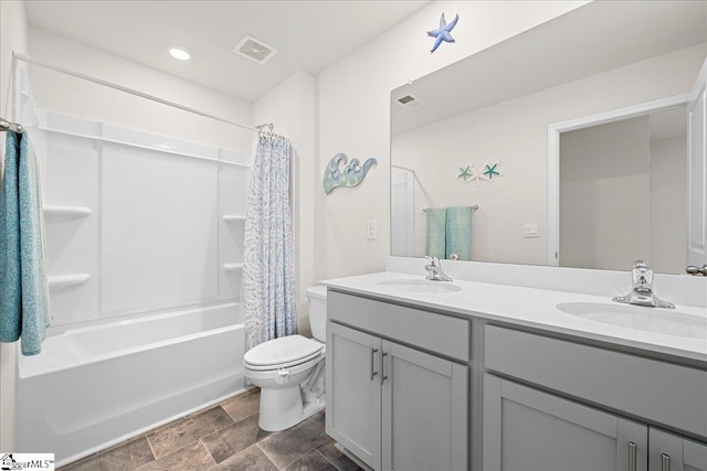 bathroom featuring double vanity, toilet, a sink, and shower / tub combo with curtain