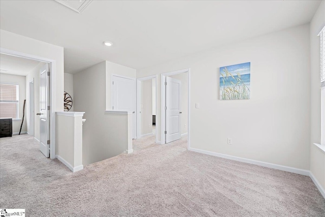 unfurnished room with baseboards and carpet