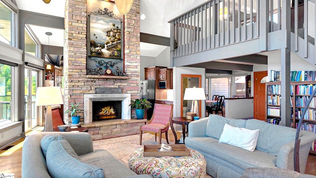 105 Seabright Cir, Cross Hill, SC 39332 - living room featuring a fireplace, visible vents, wood finished floors, and a towering ceiling