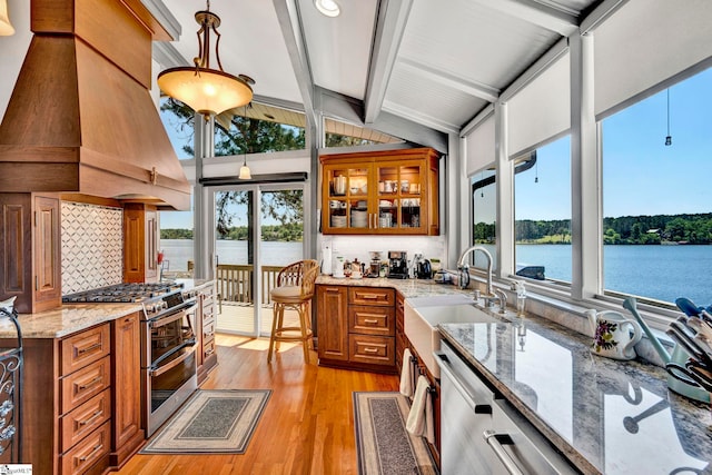 105 Seabright Cir, Cross Hill, SC 39332 - interior space featuring brown cabinetry, custom exhaust hood, vaulted ceiling with beams, a sink, and stainless steel appliances