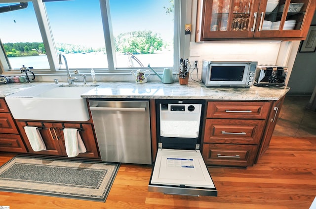 105 Seabright Cir, Cross Hill, SC 39332 - kitchen with light stone counters, a sink, dishwasher, wood finished floors, and glass insert cabinets