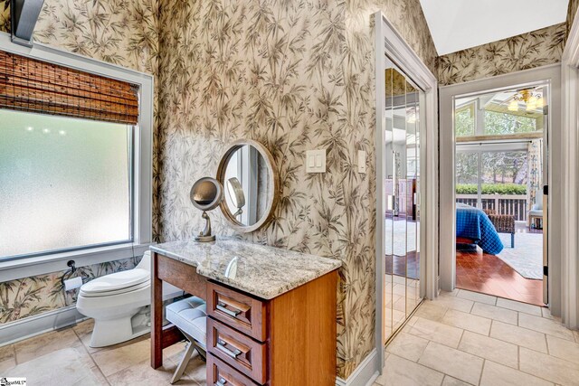 105 Seabright Cir, Cross Hill, SC 39332 - bathroom featuring a healthy amount of sunlight, baseboards, toilet, and wallpapered walls