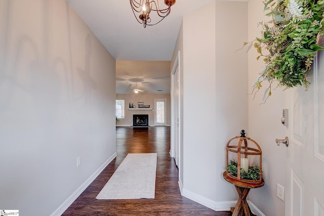 4 Creekbend Ct, Simpsonville, SC 29681 - hall featuring baseboards, dark wood-style floors, and an inviting chandelier