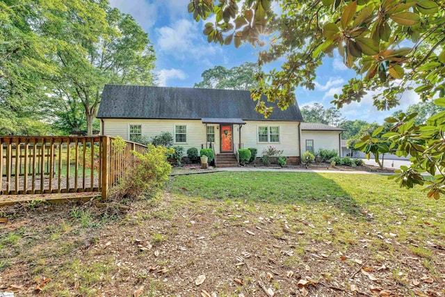 view of front of home featuring a front lawn and roof with shingles