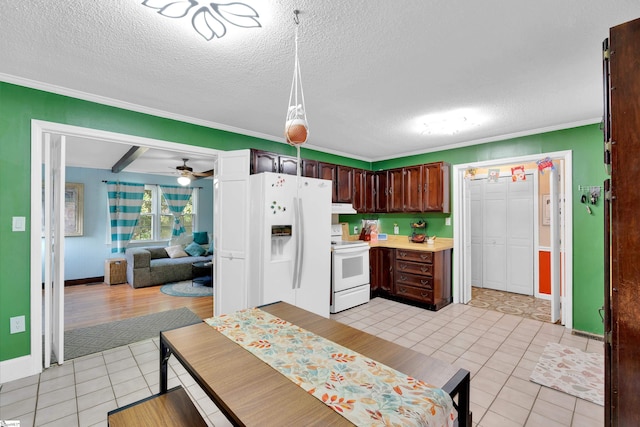 kitchen featuring crown molding, dark brown cabinets, light tile patterned floors, light countertops, and white appliances