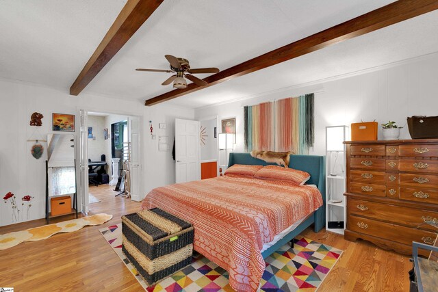 bedroom featuring beamed ceiling, ceiling fan, and light wood-style floors