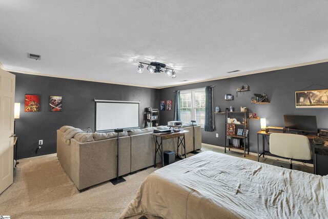 bedroom with a textured ceiling, visible vents, carpet floors, baseboards, and ornamental molding