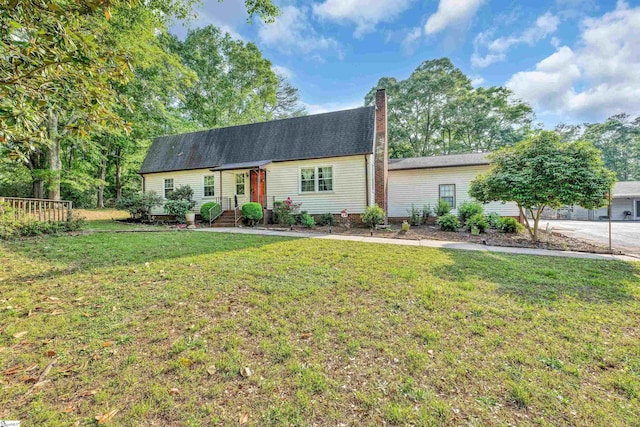 view of front of property featuring a chimney and a front lawn