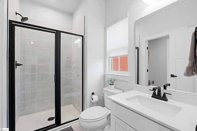 full bath featuring vanity, a shower stall, and toilet