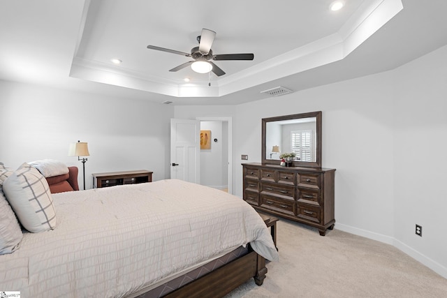 bedroom featuring light colored carpet, visible vents, a raised ceiling, baseboards, and recessed lighting