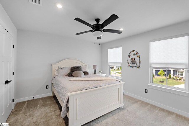bedroom featuring recessed lighting, baseboards, light colored carpet, and visible vents