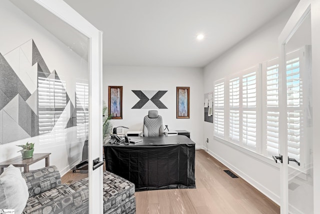 office featuring baseboards, recessed lighting, wood finished floors, and visible vents