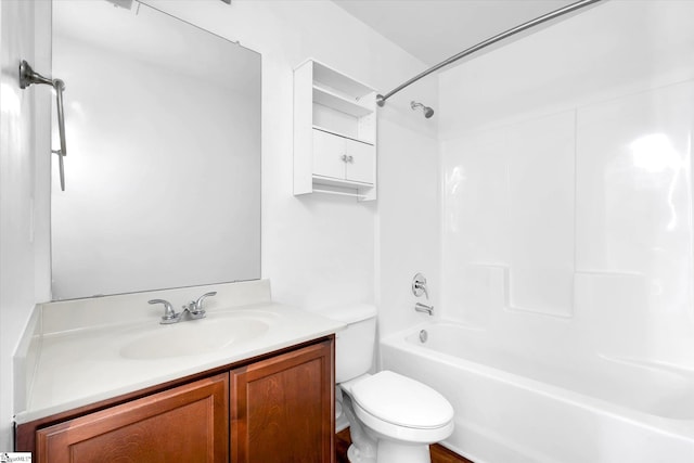 bathroom featuring bathing tub / shower combination, vanity, and toilet