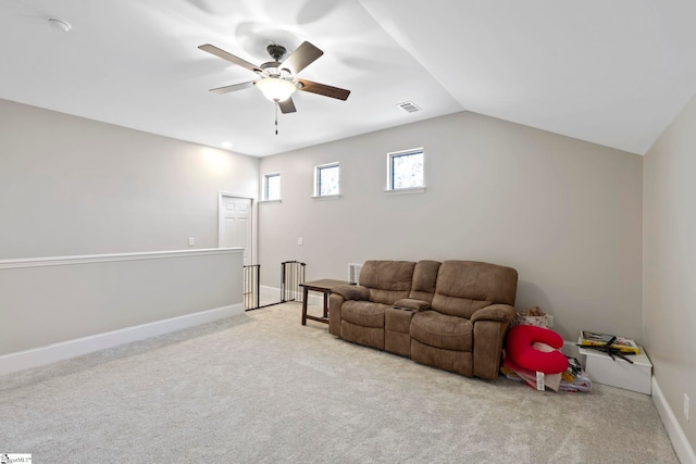 living room with carpet floors, a ceiling fan, baseboards, and visible vents