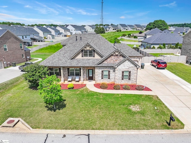 craftsman house featuring driveway, a residential view, a shingled roof, and stone siding