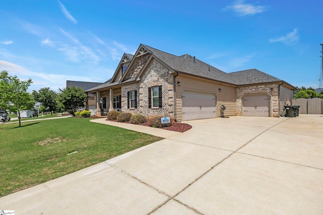 view of front of house with concrete driveway, brick siding, a front lawn, and a garage