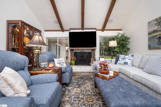 living area with a wealth of natural light, lofted ceiling with beams, and a premium fireplace