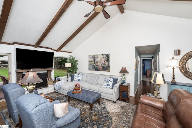 living room featuring a ceiling fan, wood finished floors, high vaulted ceiling, beamed ceiling, and a premium fireplace