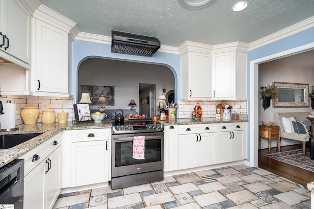 kitchen featuring electric range, white cabinetry, arched walkways, stone finish flooring, and dishwasher
