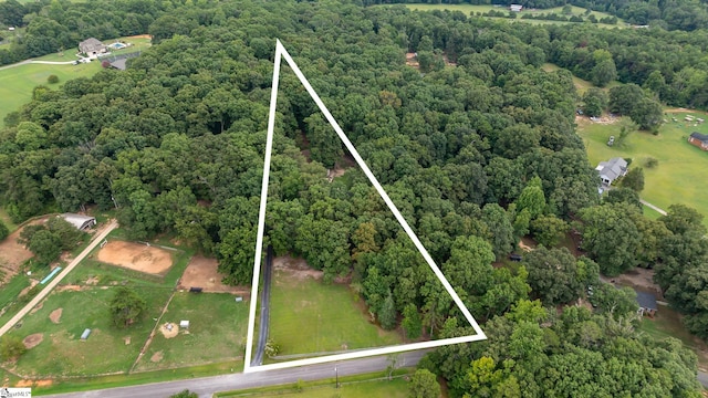 birds eye view of property featuring a forest view