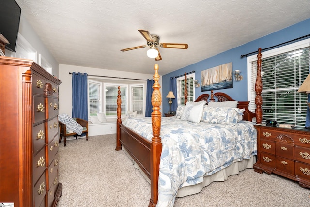 bedroom featuring a ceiling fan and carpet
