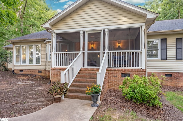 view of front of property featuring crawl space, a sunroom, and roof with shingles