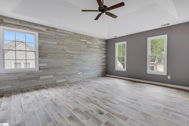205 Rosebank Way, Greenville, SC 29615 - empty room with an accent wall, a ceiling fan, baseboards, a tray ceiling, and visible vents