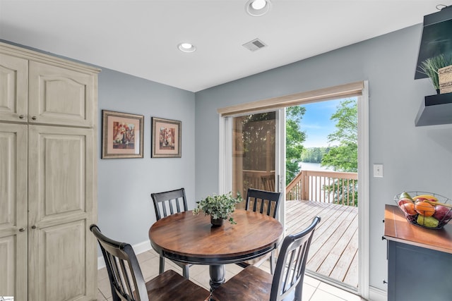 dining room featuring light tile patterned floors, baseboards, recessed lighting, and visible vents
