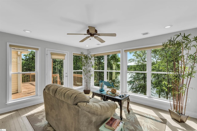 sunroom featuring wood-type flooring, recessed lighting, and visible vents