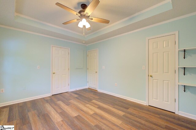 602 Habersham Ln, Easley, SC 29642 - unfurnished bedroom with crown molding, a raised ceiling, baseboards, and wood finished floors