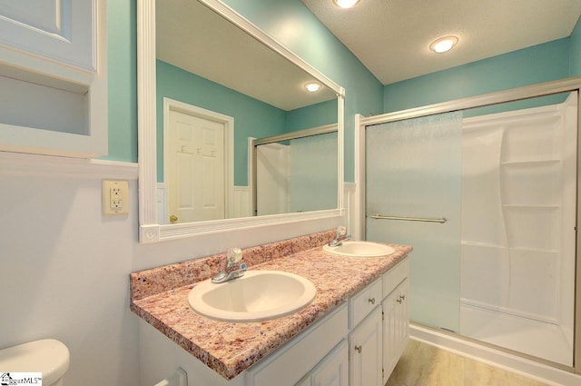 602 Habersham Ln, Easley, SC 29642 - bathroom featuring double vanity, a shower stall, a sink, and wood finished floors