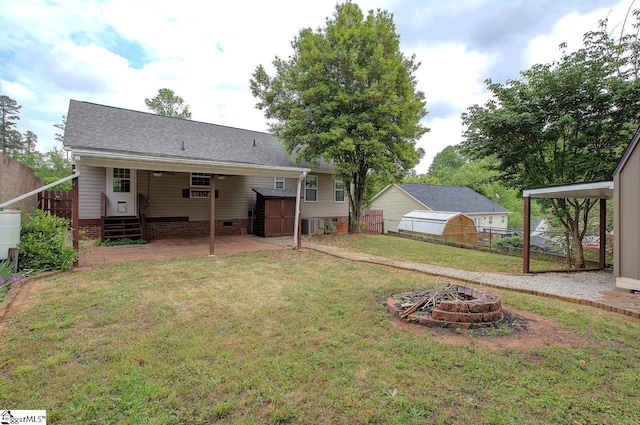 602 Habersham Ln, Easley, SC 29642 - exterior space with fence, a storage unit, an outdoor structure, a patio, and a fire pit