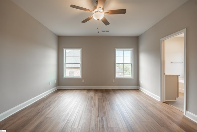 241 Carriage Gate Dr, Wellford, SC 29385 - empty room featuring a healthy amount of sunlight, a ceiling fan, wood finished floors, and visible vents