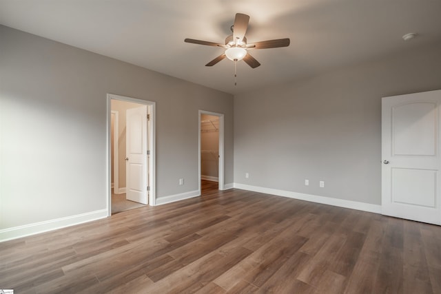 241 Carriage Gate Dr, Wellford, SC 29385 - unfurnished bedroom featuring a ceiling fan, wood finished floors, baseboards, a closet, and a spacious closet