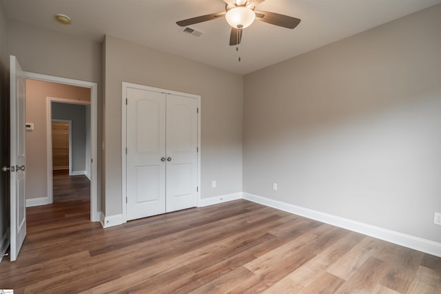 241 Carriage Gate Dr, Wellford, SC 29385 - unfurnished bedroom with baseboards, a closet, wood finished floors, and visible vents