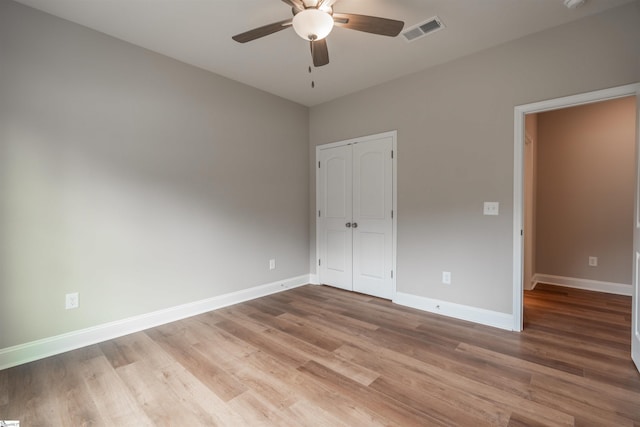 241 Carriage Gate Dr, Wellford, SC 29385 - unfurnished bedroom featuring a ceiling fan, visible vents, wood finished floors, baseboards, and a closet