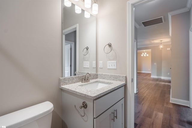 241 Carriage Gate Dr, Wellford, SC 29385 - half bathroom featuring crown molding, a notable chandelier, toilet, wood finished floors, and visible vents