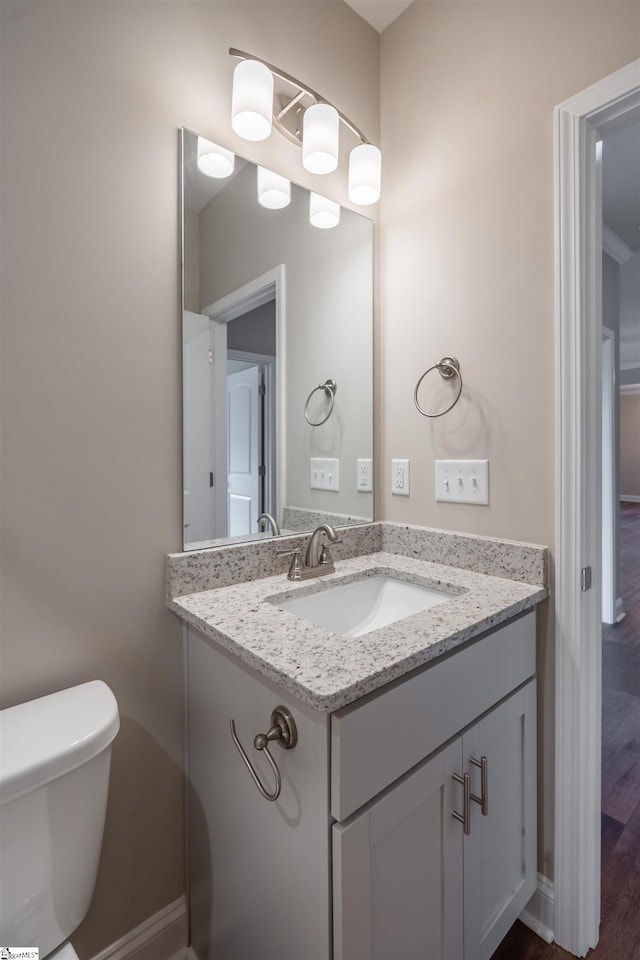 241 Carriage Gate Dr, Wellford, SC 29385 - half bathroom featuring baseboards, wood finished floors, toilet, and vanity