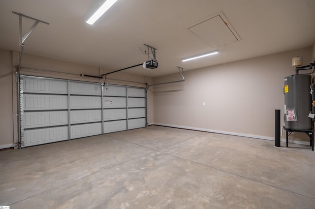 241 Carriage Gate Dr, Wellford, SC 29385 - garage with baseboards, a garage door opener, and electric water heater