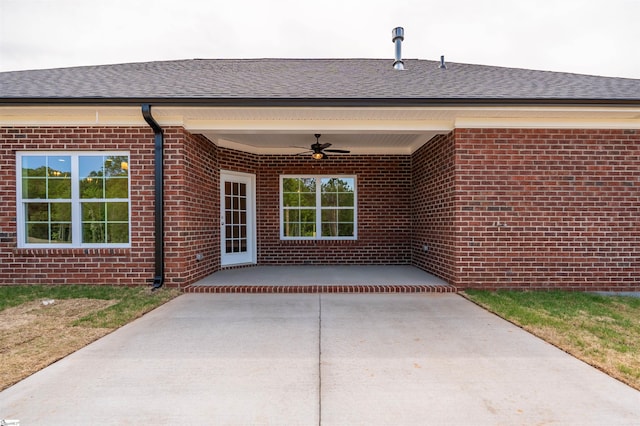 241 Carriage Gate Dr, Wellford, SC 29385 - entrance to property with brick siding, a ceiling fan, a shingled roof, and a patio