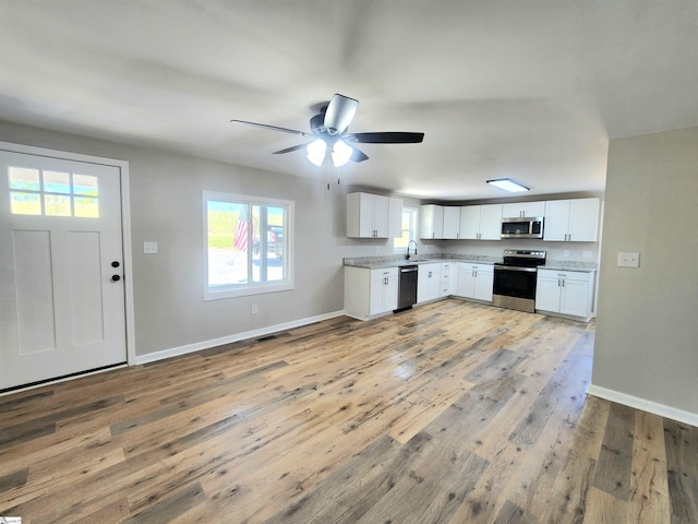 509 Allgood Bridge Rd, Pickens, SC 29671 - kitchen with baseboards, light wood-style flooring, white cabinetry, and stainless steel appliances