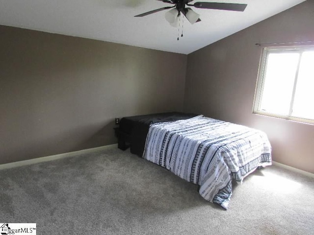 bedroom featuring carpet floors, baseboards, ceiling fan, and vaulted ceiling