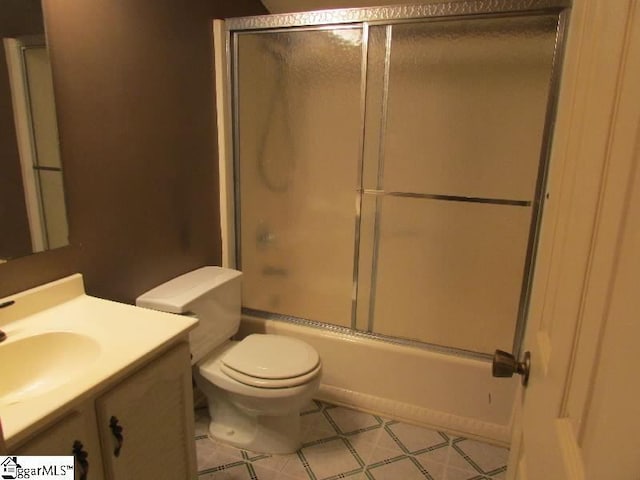 full bathroom with toilet, combined bath / shower with glass door, and vanity