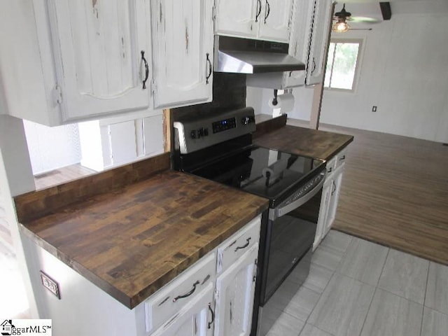 kitchen with ceiling fan, light tile patterned floors, white cabinets, electric stove, and under cabinet range hood