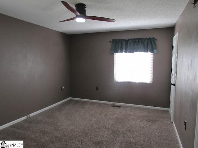 carpeted empty room featuring baseboards and ceiling fan