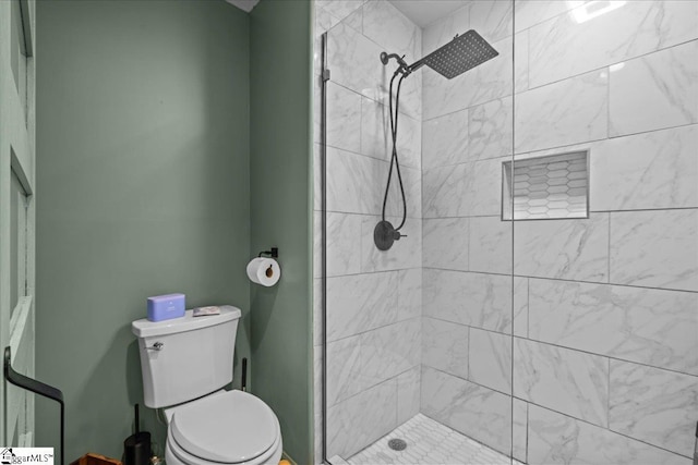 full bathroom with a stall shower and toilet