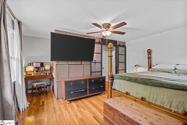 bedroom with ceiling fan and light wood-style flooring
