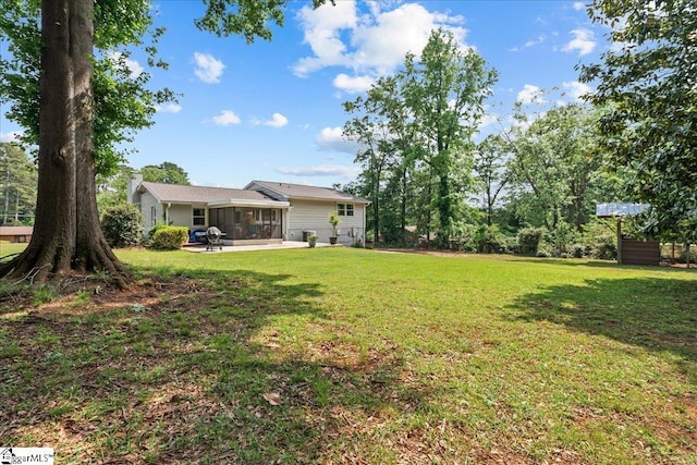 view of yard featuring a sunroom and a patio