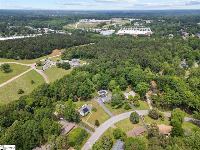 drone / aerial view with a wooded view